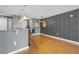 Open-concept living room with hardwood floors, bar seating, and modern lighting at 3338 Peachtree Ne Rd # 1010, Atlanta, GA 30326