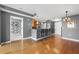 Living room featuring modern kitchen, hardwood floors, and sleek pendant lighting at 3338 Peachtree Ne Rd # 1010, Atlanta, GA 30326