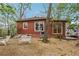 Cozy backyard featuring wooden chairs and a charming red brick home with a small window at 698 Bellemeade Nw Ave, Atlanta, GA 30318