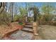 Stone steps and an arched gate invite you into the backyard's outdoor living space at 698 Bellemeade Nw Ave, Atlanta, GA 30318