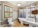 Bathroom with vintage style and features including pedestal sink, toilet, and claw foot tub at 698 Bellemeade Nw Ave, Atlanta, GA 30318