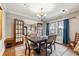 Elegant dining room with a large table, ornate rug, and ample natural light at 698 Bellemeade Nw Ave, Atlanta, GA 30318