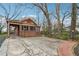 Long concrete driveway leading to a one-story brick home with a detached garage at 698 Bellemeade Nw Ave, Atlanta, GA 30318