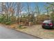 Brick steps leading to a driveway with a parked car in front of a brick home at 698 Bellemeade Nw Ave, Atlanta, GA 30318