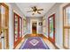 Inviting hallway featuring hardwood floors, a colorful rug, natural light, and multiple entryways at 698 Bellemeade Nw Ave, Atlanta, GA 30318