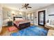 Bright bedroom with hardwood floors, a ceiling fan, decor, and a decorative metal door to a porch at 698 Bellemeade Nw Ave, Atlanta, GA 30318