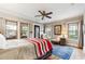 Sunlit bedroom with hardwood floors, many windows, decor, and a decorative metal door to a porch at 698 Bellemeade Nw Ave, Atlanta, GA 30318