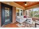 Cozy sunroom porch with cushioned seating, brick walls and ceiling fan at 698 Bellemeade Nw Ave, Atlanta, GA 30318