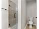 Bathroom featuring walk-in shower with glass door and a modern-style toilet at 7260 Foxberry Ct, Cumming, GA 30041