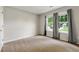 Comfortable bedroom featuring plush carpeting and bright natural light from double window at 7260 Foxberry Ct, Cumming, GA 30041