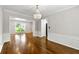 Spacious dining room featuring hardwood floors, elegant wainscoting, and an eye-catching chandelier at 7260 Foxberry Ct, Cumming, GA 30041