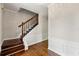 Welcoming foyer featuring hardwood floors, elegant wainscoting, and a staircase with dark wood railings at 7260 Foxberry Ct, Cumming, GA 30041