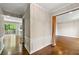 Inviting hallway with hardwood flooring, decorative molding, and access to multiple rooms in the home at 7260 Foxberry Ct, Cumming, GA 30041