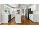 Bright kitchen with stainless steel appliances, white cabinets and a large window providing ample natural light at 7260 Foxberry Ct, Cumming, GA 30041