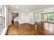 Open-concept living room showcasing hardwood floors and seamlessly connecting multiple living spaces at 7260 Foxberry Ct, Cumming, GA 30041