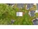 This aerial view highlights the property and the outbuilding nestled among mature trees in a suburban neighborhood at 151 Mark Se Ln, Smyrna, GA 30082