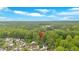 Aerial view of the property showcases its location in a lush, green neighborhood with mature trees at 151 Mark Se Ln, Smyrna, GA 30082