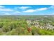Aerial view of the property showcases its location in a lush, green neighborhood with a nearby pond at 151 Mark Se Ln, Smyrna, GA 30082