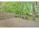 Large wooden deck surrounded by trees and lush greenery, perfect for outdoor entertaining at 151 Mark Se Ln, Smyrna, GA 30082