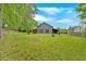 A large backyard with a basketball hoop and mature trees, perfect for outdoor activities and relaxation at 151 Mark Se Ln, Smyrna, GA 30082