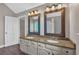 Elegant bathroom with double vanity, granite countertops, framed mirrors, and modern fixtures at 151 Mark Se Ln, Smyrna, GA 30082