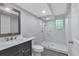 Updated bathroom featuring a sleek vanity with marble counters and a glass-enclosed shower with marble tile at 151 Mark Se Ln, Smyrna, GA 30082