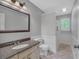 Neutral bathroom showcasing a granite vanity, large mirror, and combination shower and tub at 151 Mark Se Ln, Smyrna, GA 30082