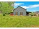 Unique building with a metal roof and red screened-in porch, set in a spacious green yard surrounded by trees at 151 Mark Se Ln, Smyrna, GA 30082