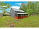 Unique building with a metal roof and red screened-in porch, set in a spacious green yard surrounded by trees at 151 Mark Se Ln, Smyrna, GA 30082