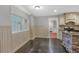 Dining Room with hardwood floors, wainscoting, view of kitchen, and large bright windows at 151 Mark Se Ln, Smyrna, GA 30082