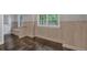 View of dining room shows hardwood floors, white wainscoting, white windows and neutral walls at 151 Mark Se Ln, Smyrna, GA 30082