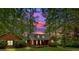 Brick home at sunset, framed by tall trees and beautiful landscaping at 151 Mark Se Ln, Smyrna, GA 30082