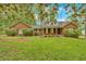 Charming brick home featuring a well-maintained lawn and mature trees at 151 Mark Se Ln, Smyrna, GA 30082