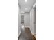Hallway featuring wood floors, recessed lighting, and white walls, offering a clean aesthetic at 151 Mark Se Ln, Smyrna, GA 30082