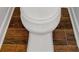 Close-up showcasing a toilet with wood-look tile flooring, adding a touch of rustic charm to the bathroom at 151 Mark Se Ln, Smyrna, GA 30082