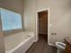 Bathroom featuring a soaking tub and a separate toilet area for added privacy at 16 Grandview Ct, Powder Springs, GA 30127