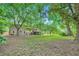 Exterior view of the backyard with mature trees and a deck on the house at 2687 Goodfellows Rd, Tucker, GA 30084