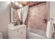 Stylish bathroom featuring tiled walls, wood ceiling, and decorative lighted mirror at 2687 Goodfellows Rd, Tucker, GA 30084