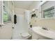 Bright bathroom with a shower, tiled walls, and a window for natural light at 2687 Goodfellows Rd, Tucker, GA 30084