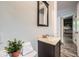 Modern bathroom vanity with dark cabinets, stone countertop, and a decorative mirror at 2687 Goodfellows Rd, Tucker, GA 30084