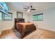 Cozy bedroom featuring hardwood floors, a ceiling fan, and two windows with natural light at 2687 Goodfellows Rd, Tucker, GA 30084