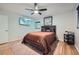 Comfortable bedroom with neutral walls, ceiling fan, and a wall-mounted TV at 2687 Goodfellows Rd, Tucker, GA 30084