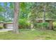 Well-maintained brick home exterior with lush lawn, professional landscaping, and a two-car garage at 2687 Goodfellows Rd, Tucker, GA 30084