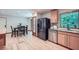Modern kitchen with stainless steel appliances, hardwood floors, and an adjacent dining area at 2687 Goodfellows Rd, Tucker, GA 30084