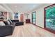 Spacious living room featuring hardwood floors, natural light, and a comfortable sofa at 2687 Goodfellows Rd, Tucker, GA 30084