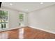 Sunlit bedroom featuring hardwood floors and dual windows providing serene outdoor views at 3270 Brookview Dr, Marietta, GA 30068