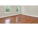 Spacious bedroom with hardwood floors, neutral walls, white trim, and windows offering natural light at 3270 Brookview Dr, Marietta, GA 30068