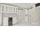 Charming butler pantry with modern white cabinets, wine storage, marble countertops, and a stylish beverage refrigerator at 3270 Brookview Dr, Marietta, GA 30068