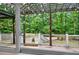 Wooden deck with a wooden pergola offers views of the fenced in yard and the lush greenery at 3270 Brookview Dr, Marietta, GA 30068