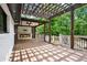 Spacious deck featuring a fireplace, ceiling fan, and stylish pergola, perfect for outdoor entertaining at 3270 Brookview Dr, Marietta, GA 30068
